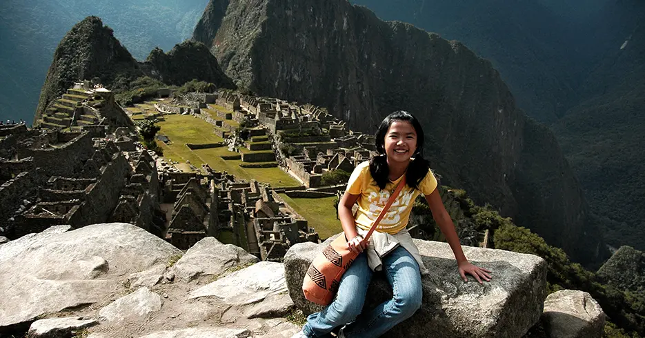 Tu Aventura Inca Comienza Aquí: Todo Sobre el Tren de Cusco a Machu Picchu 11 niña feliz en machu picchu, una de las 7 maravillas del mundo moderno