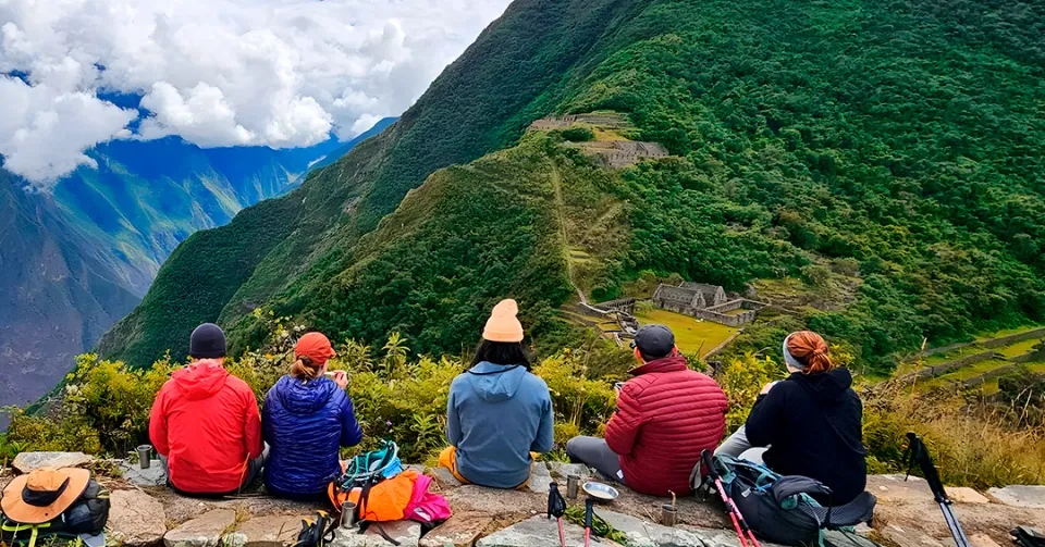 5-Day Choquequirao Trekking Tour in Peru Hikers resting on a ridge with a panoramic view of the deep canyon on the Choquequirao Trek.